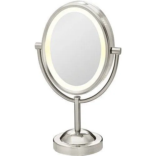 New in box! Conair True Glow Satin Nickel Oval Lighted Mirror! Double sided 1x/7x magnification, produces a soft halo, gentle glow!